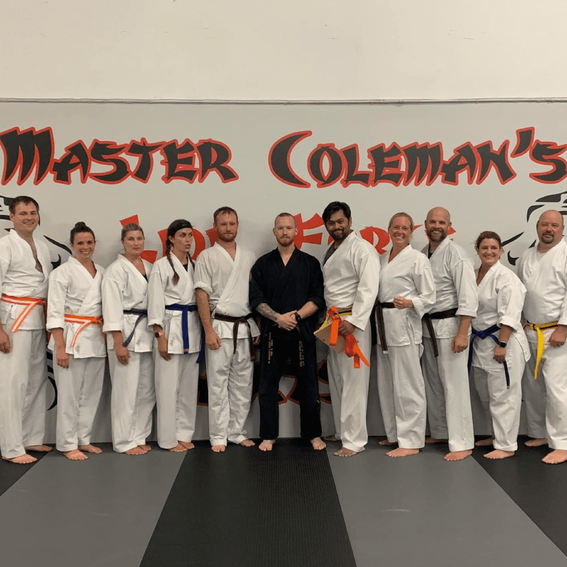 a group of people, possibly martial arts students, posing together for a photo